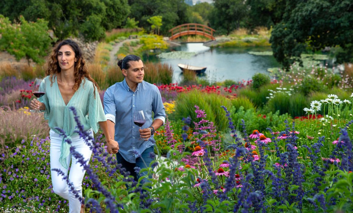 Couple strolling Coursey Graves mountain top estate winery and gardens on a wine tour